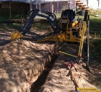 John Deere 318 Micro Hoe digging by Jake T.