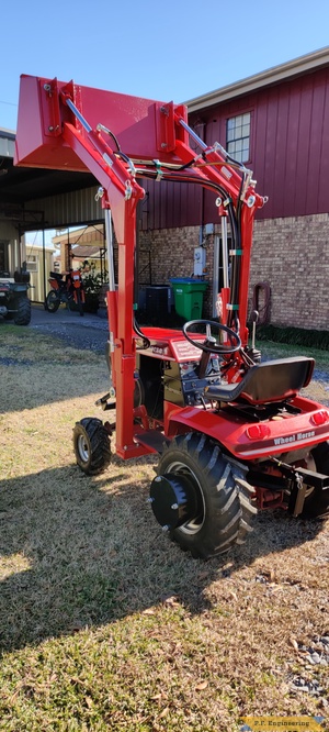 Don A. and his Wheelhorse 310-8 loader in Thibodaux, LA bucket raised left rear view